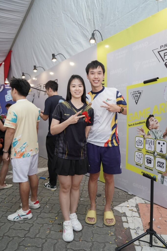 Two visitors posing at the PRIND booth