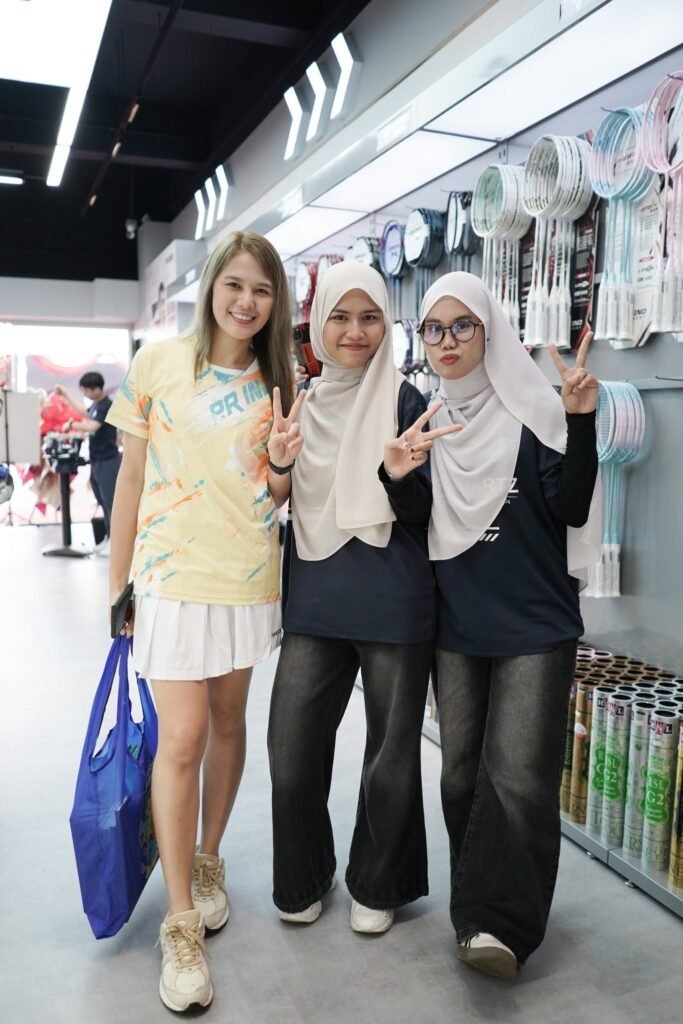 Three PRIND Austin JB staff members smiling inside the store